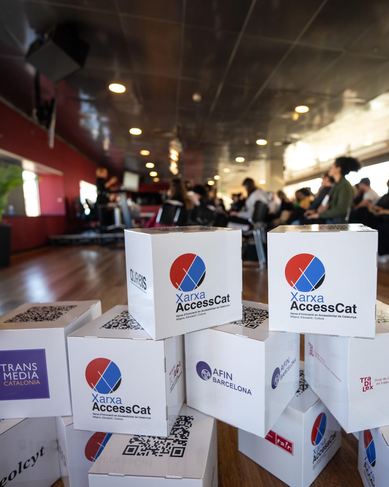 Cardboard cubes with the logos of the research groups of the Network decorate the CCCB at the AccessCat Innovation Day.